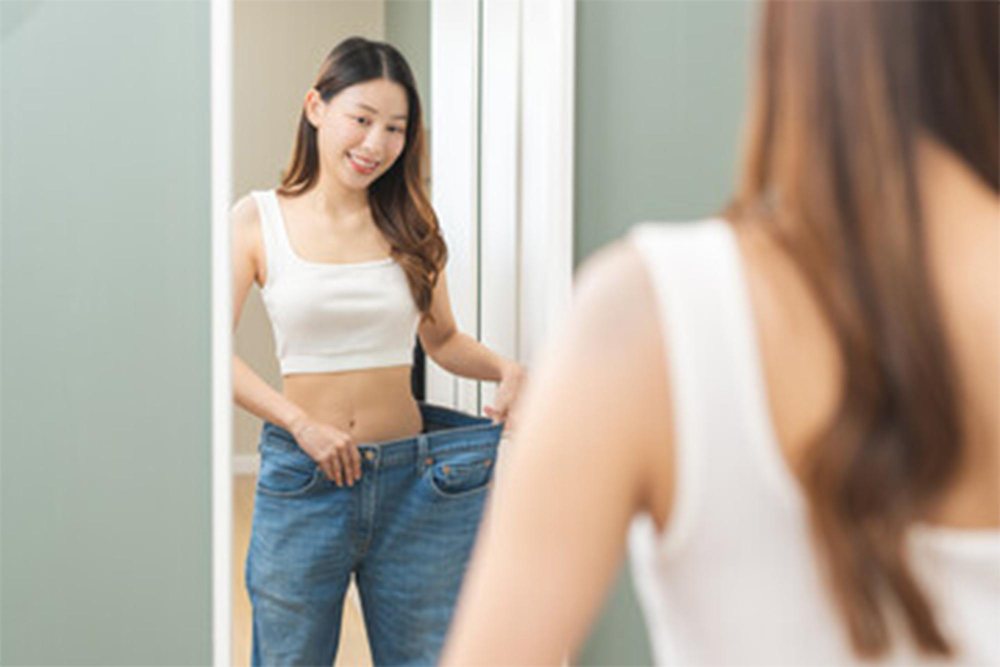 A young female celebrating weight loss