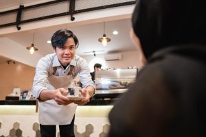 A waiter serving food in a corporate catering
