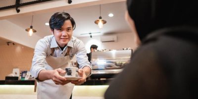 A waiter serving food in a corporate catering