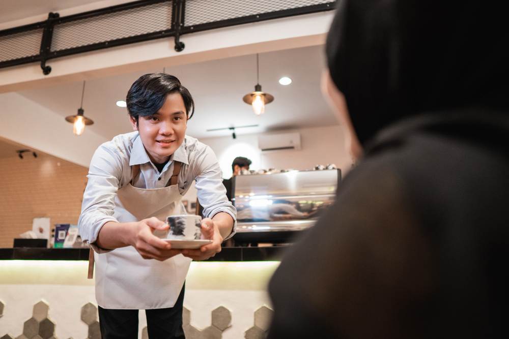A waiter serving food in a corporate catering