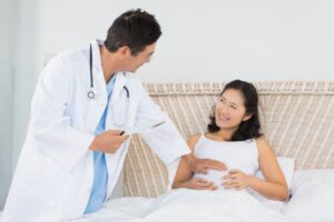 A doctor is checking a female patient.